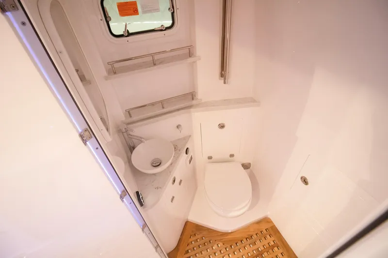 Slide: The Image of Luxurious bathroom interior of 2026 HCB 48 Campeon boat, featuring modern fixtures and wooden flooring. - 9