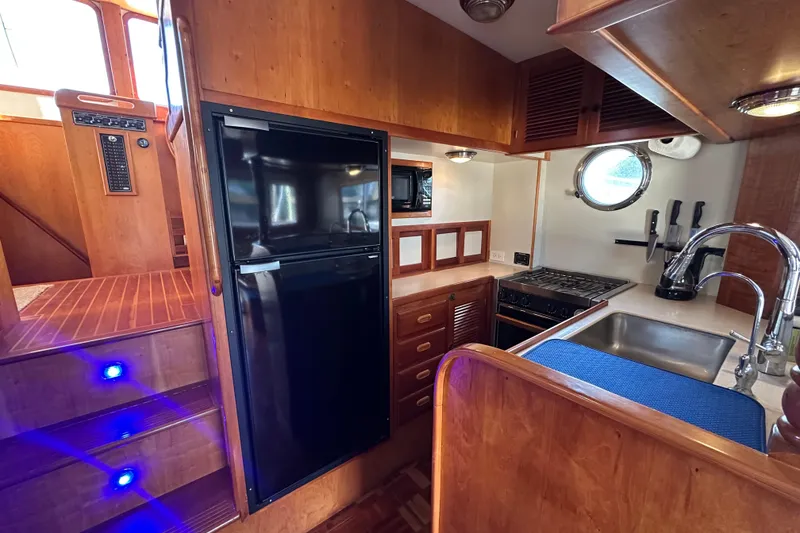 Slide: The Image of Interior of 1999 Kadey-Krogen 39 yacht with wooden shelves and nautical decor. - 10