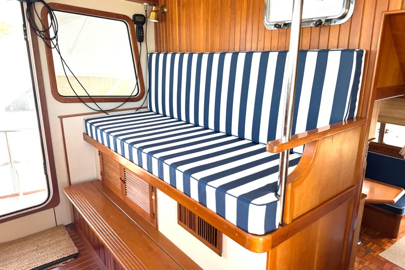 Slide: The Image of Interior of 1999 Kadey-Krogen 39 with striped seating and vibrant cushions. - 14