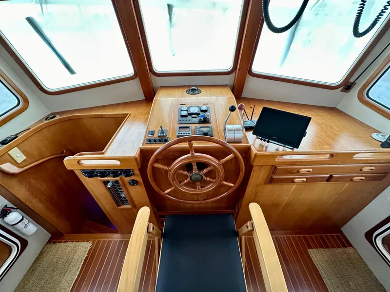 Slide: The Image of Interior of 1999 Kadey-Krogen 39 boat with wooden helm and navigation equipment. - 16