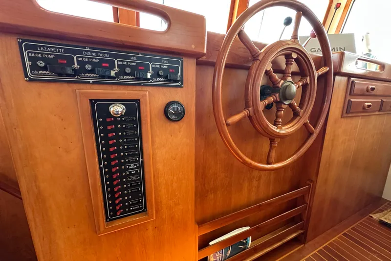 Slide: The Image of Garmin device on 1999 Kadey-Krogen 39 yacht, wooden interior, basket with binoculars. - 19