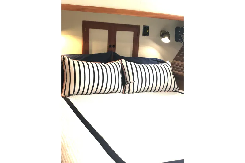 Slide: The Image of Luxurious 1999 Kadey-Krogen 39 yacht cabin with cozy bed and elegant wood paneling. - 28