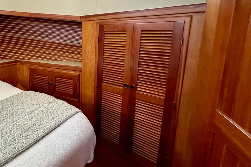 Slide: The Image of Elegant 1999 Kadey-Krogen 39 yacht interior with wooden cabinetry and illuminated staircase. - 29