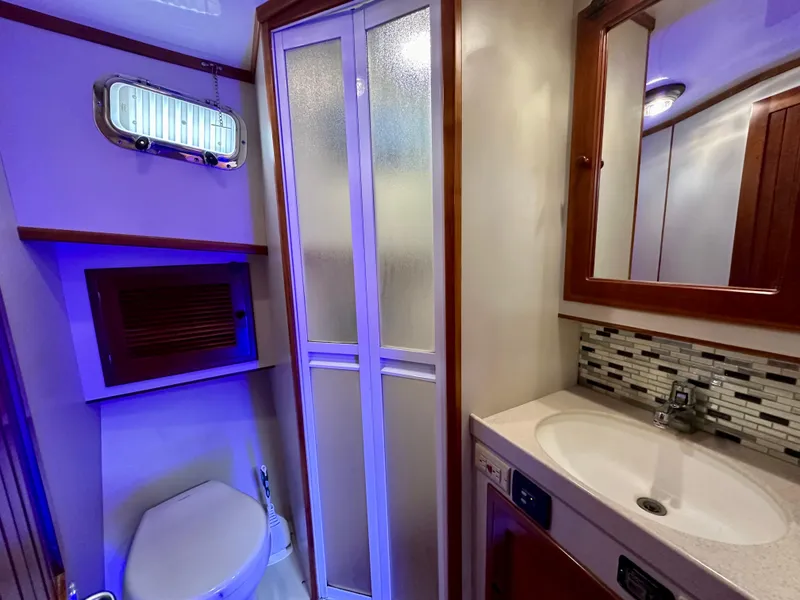 Slide: The Image of Shower area in 1999 Kadey-Krogen 39 yacht, featuring chrome fixtures and white walls. - 31