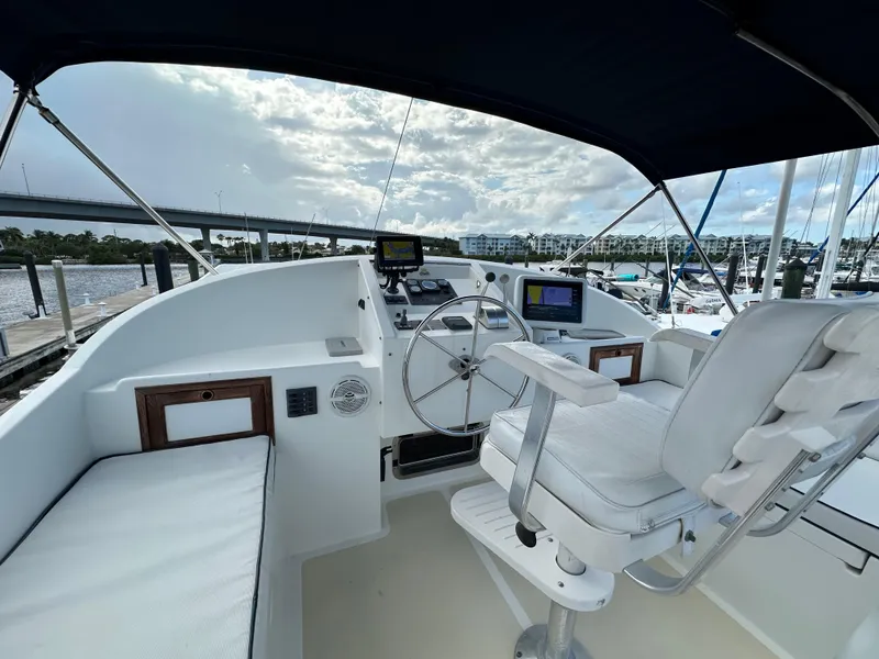 Slide: The Image of Engine room of a 1999 Kadey-Krogen 39 boat, featuring tools and equipment. - 32