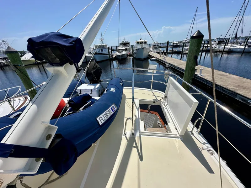 Slide: The Image of 1999 Kadey-Krogen 39 yacht deck with chairs and American flag. - 37