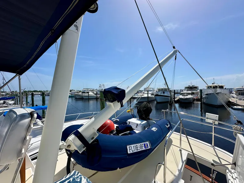 Slide: The Image of 1999 Kadey-Krogen 39 yacht deck with wooden door and ladder, docked at marina. - 38