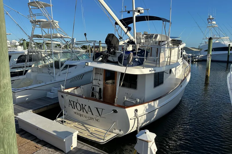 Slide: The Image of Interior of 1999 Kadey-Krogen 39 yacht with wood paneling and cozy seating area. - 4
