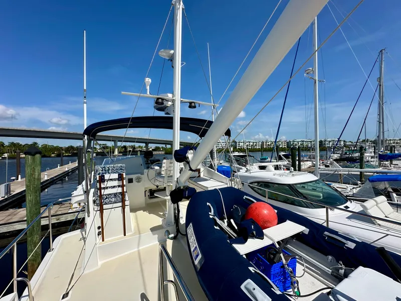 Slide: The Image of Bow view of 1999 Kadey-Krogen 39 yacht docked in a marina under clear blue skies. - 40