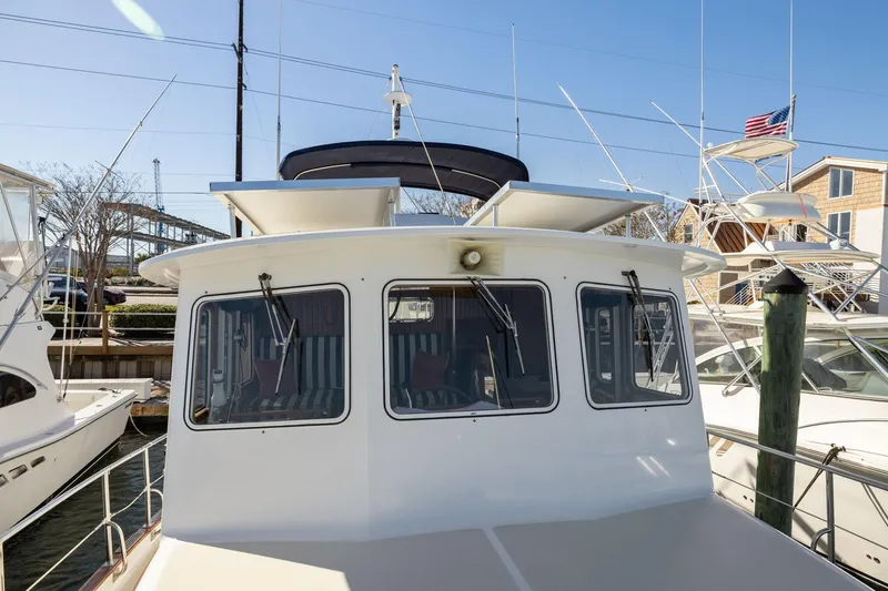 Slide: The Image of 1999 Kadey-Krogen 39 yacht docked, showcasing front windows and deck area. - 41