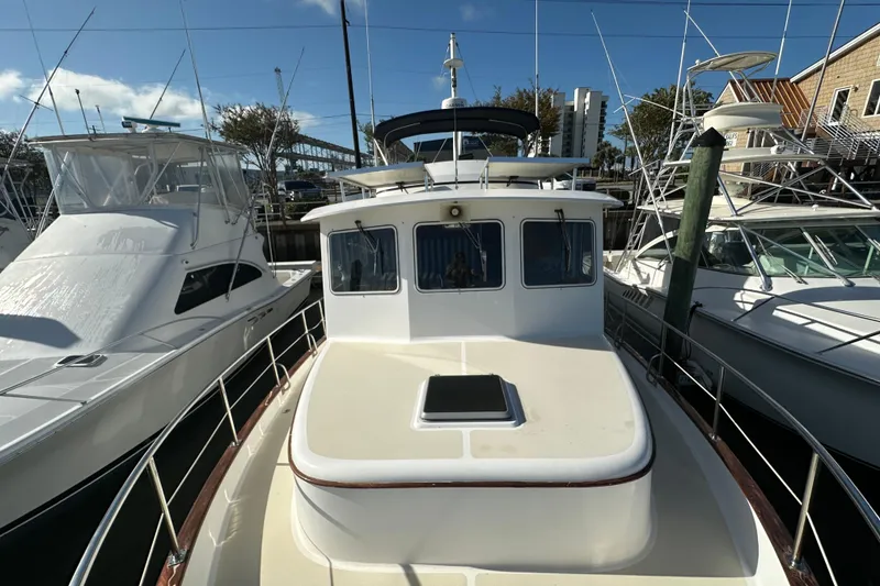 Slide: The Image of 1999 Kadey-Krogen 39 yacht with solar panels docked in a marina. - 46
