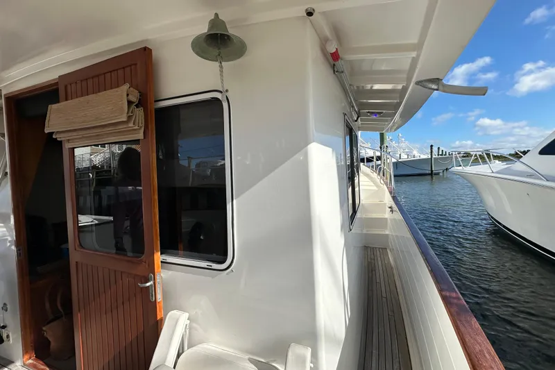 Slide: The Image of 1999 Kadey-Krogen 39 yacht docked at marina under clear blue sky. - 47