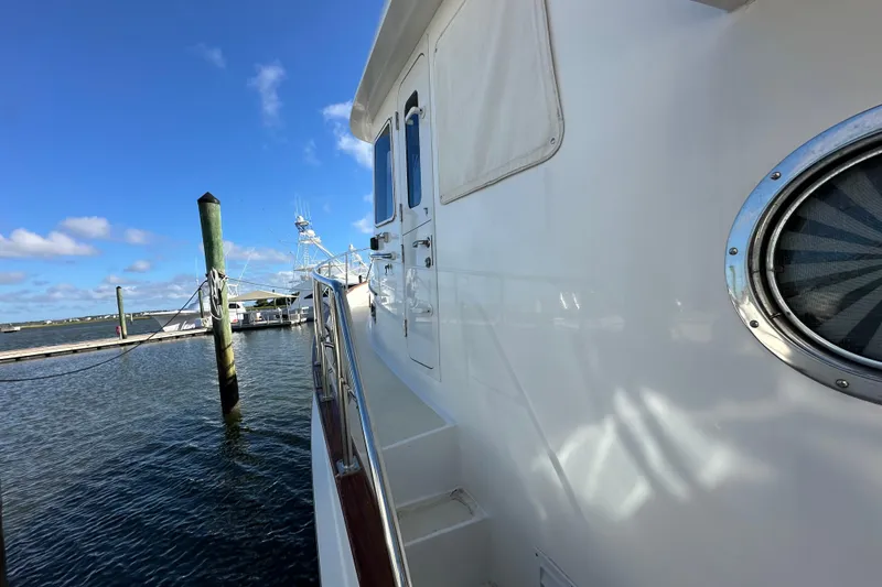 Slide: The Image of 1999 Kadey-Krogen 39 yacht docked at marina under clear blue sky. - 48