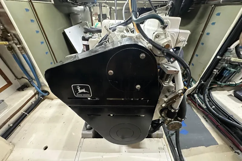 Slide: The Image of 1999 Kadey-Krogen 39 yacht docked between two boats in a marina. - 50