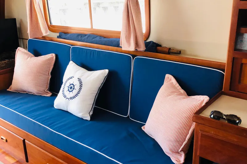 Slide: The Image of Cozy interior of 1999 Kadey-Krogen 39 yacht with blue seating and wooden accents. - 7