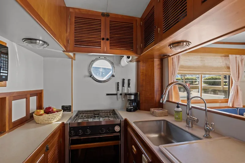 Slide: The Image of Cozy 1999 Kadey-Krogen 39 yacht kitchen with wooden cabinets and modern appliances. - 8