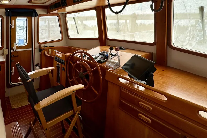 Slide: The Image of 1999 Kadey-Krogen 39 boat helm with wooden steering wheel and Garmin navigation system. - 17