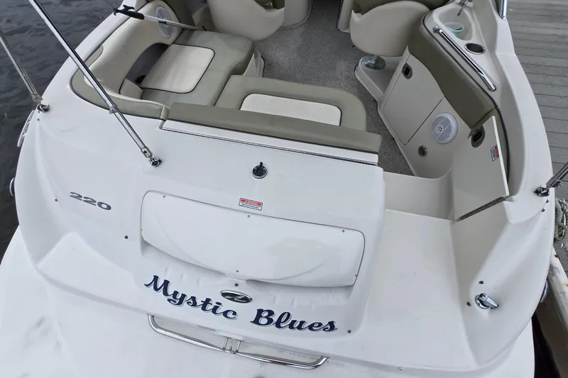 Slide: The Image of 2005 Sea Ray 220 Sundeck boat interior with seating and "Mystic Blues" name. - 14