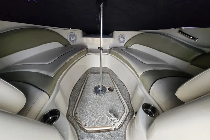 Slide: The Image of Interior of a 2005 Sea Ray 220 Sundeck boat with cushioned seating and speakers. - 5