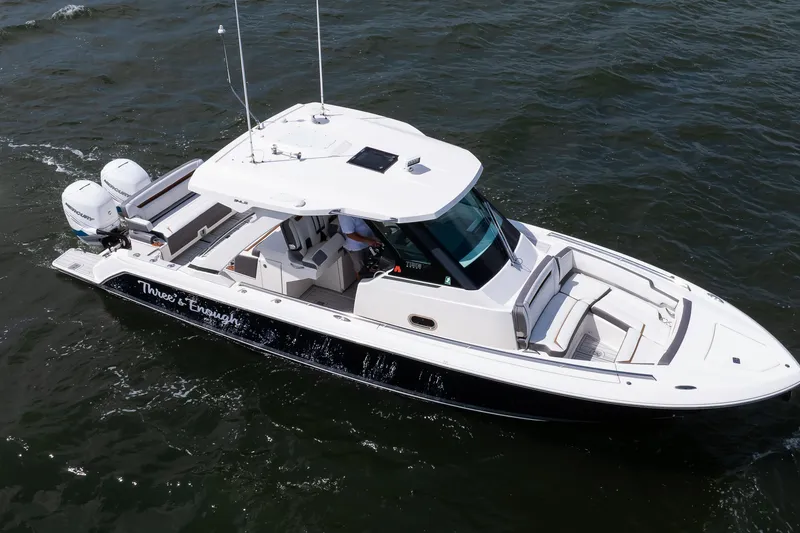 Slide: The Image of 2020 Tiara Sport 34 LS boat cruising on open water, side view. - 11