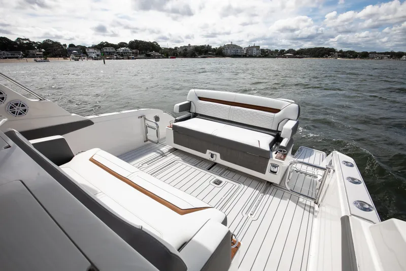 Slide: The Image of 2020 Tiara Sport 34 LS boat interior with seating, on a scenic waterfront. - 14