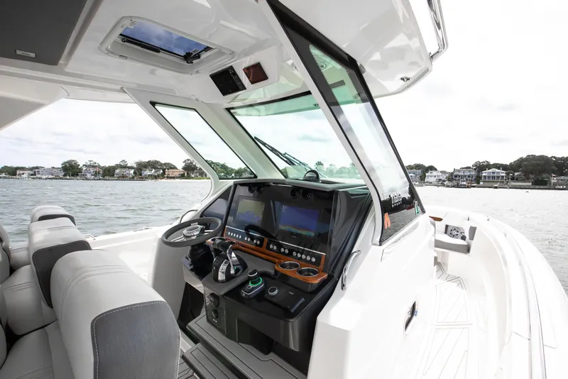 Slide: The Image of 2020 Tiara Sport 34 LS boat interior with modern dashboard and steering wheel. - 19