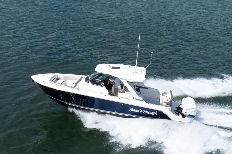 Slide: The Image of 2020 Tiara Sport 34 LS boat cruising on open water, side view. - 2