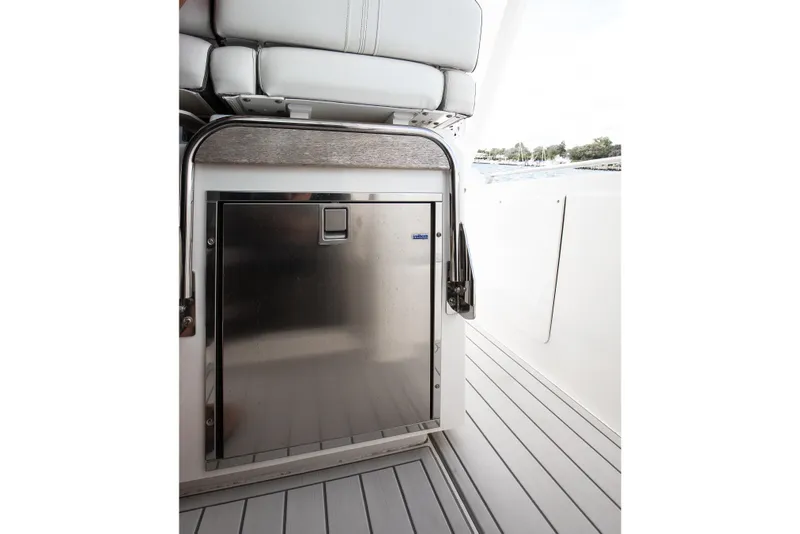 Slide: The Image of 2020 Tiara Sport 34 LS boat interior with stainless steel storage compartment. - 21