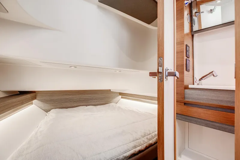 Slide: The Image of 2020 Tiara Sport 34 LS cabin interior with bed and wooden accents. - 25