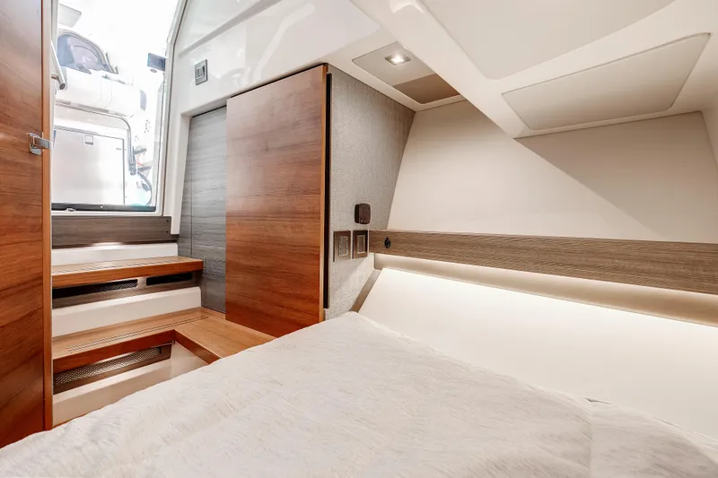 Slide: The Image of 2020 Tiara Sport 34 LS cabin interior with wooden accents and modern design. - 27