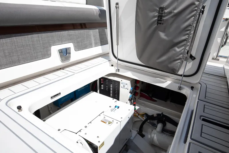 Slide: The Image of 2020 Tiara Sport 34 LS boat storage compartment with open hatch and visible equipment. - 28