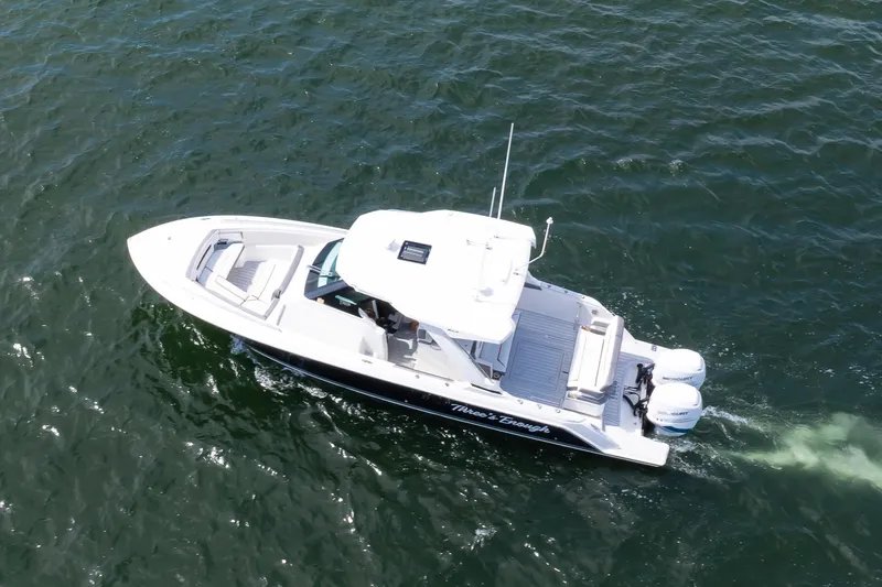 Slide: The Image of 2020 Tiara Sport 34 LS boat cruising on open water, aerial view. - 4