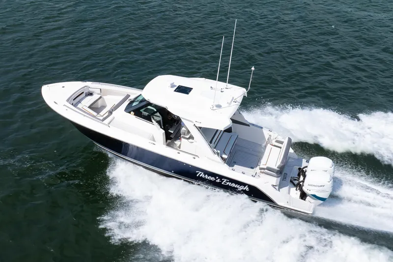 Slide: The Image of 2020 Tiara Sport 34 LS boat cruising on open water, side view. - 5