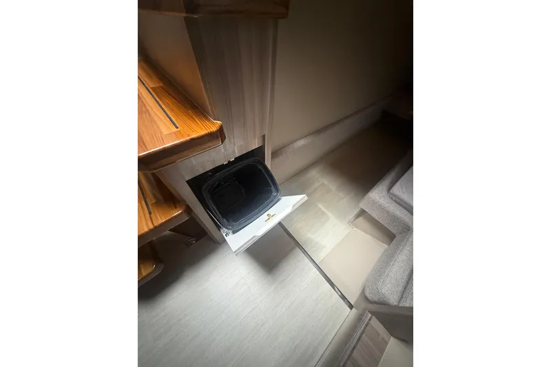 Slide: The Image of Interior of Hanover 447 (2025) showing open storage compartment under wooden stairs. - 34