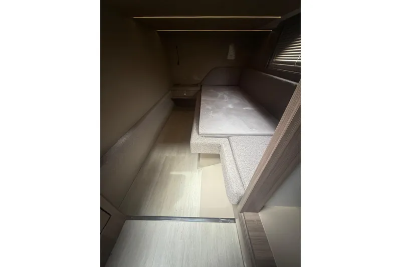 Slide: The Image of Interior of 2025 Hanover 447, featuring a compact, modern sleeping area with soft lighting. - 36