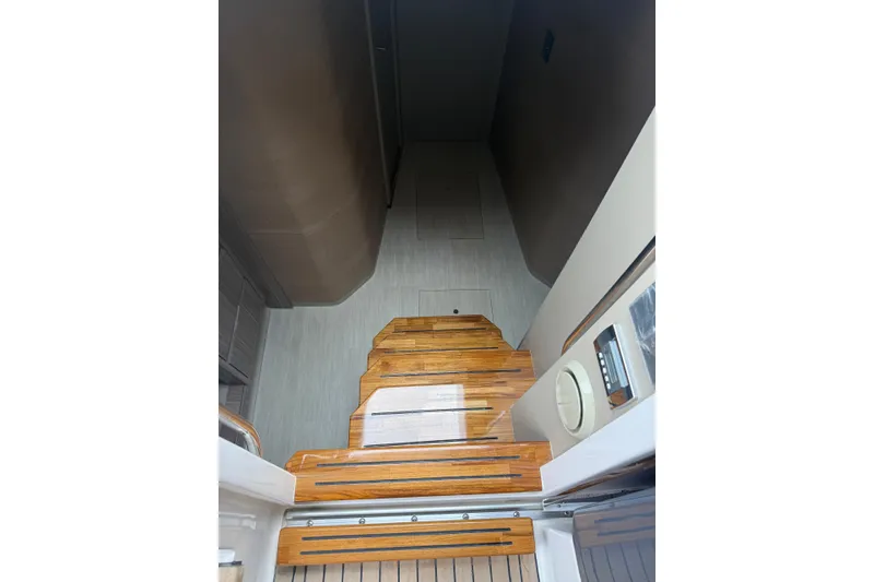 Slide: The Image of Wooden stairs inside 2025 Hanover 447 yacht, leading to lower deck area. - 37