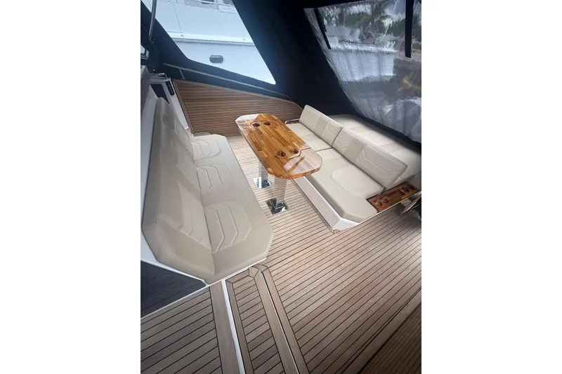 Slide: The Image of Luxurious interior of 2025 Hanover 447 yacht with beige seating and wooden table. - 42