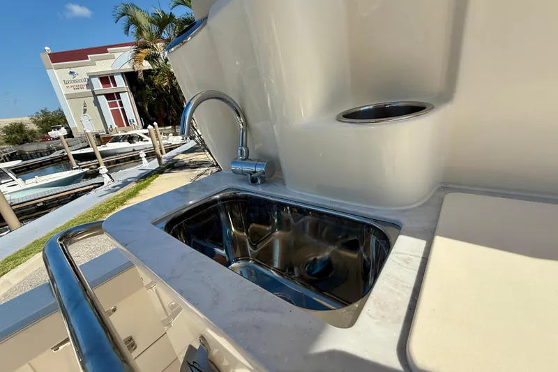 Slide: The Image of 2026 Scout 260 LXF boat sink and faucet detail at marina. - 13