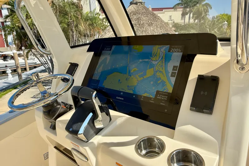 Slide: The Image of 2026 Scout 260 LXF boat dashboard with Garmin navigation display and steering wheel. - 18
