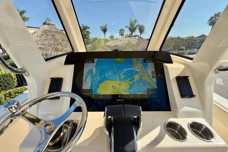 Slide: The Image of 2026 Scout 260 LXF boat dashboard with Garmin navigation display and steering wheel. - 19
