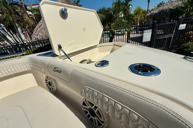 Slide: The Image of 2026 Scout 260 LXF boat interior with open storage compartment and luxurious seating. - 27