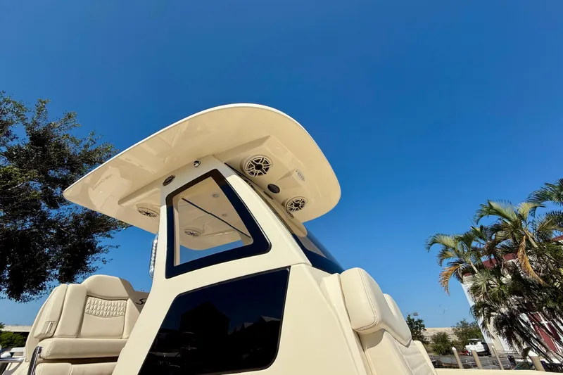 Slide: The Image of 2026 Scout 260 LXF boat with sleek design under clear blue sky. - 28