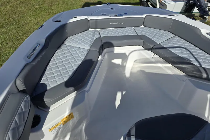 Slide: The Image of 2026 NauticStar 191 Hybrid boat interior with gray cushioned seating and diamond pattern design. - 11