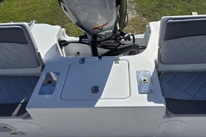 Slide: The Image of 2026 NauticStar 191 Hybrid boat interior with seating and engine view. - 3