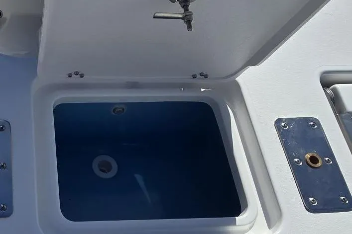 Slide: The Image of 2026 NauticStar 191 Hybrid boat livewell with open lid and faucet. - 4