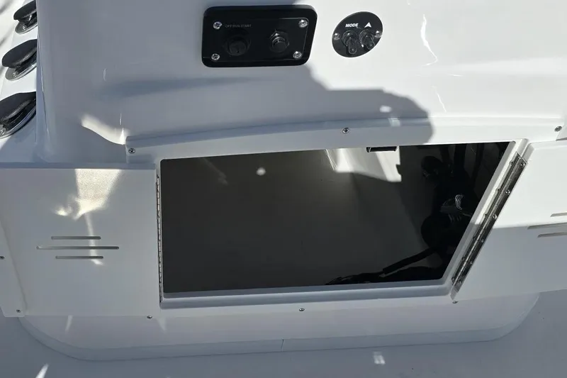 Slide: The Image of 2026 NauticStar 191 Hybrid boat console with open storage compartment and control panel. - 7