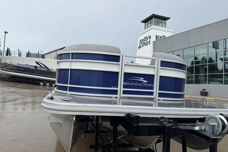 Slide: The Image of 2022 Bennington 26 LXSB pontoon boat displayed at dealership. - 19