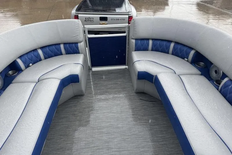 Slide: The Image of 2022 Bennington 26 LXSB pontoon boat interior with blue and gray seating. - 3