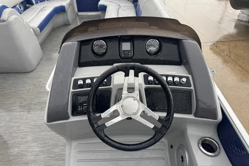 Slide: The Image of 2022 Bennington 26 LXSB boat dashboard with steering wheel and control panel. - 5