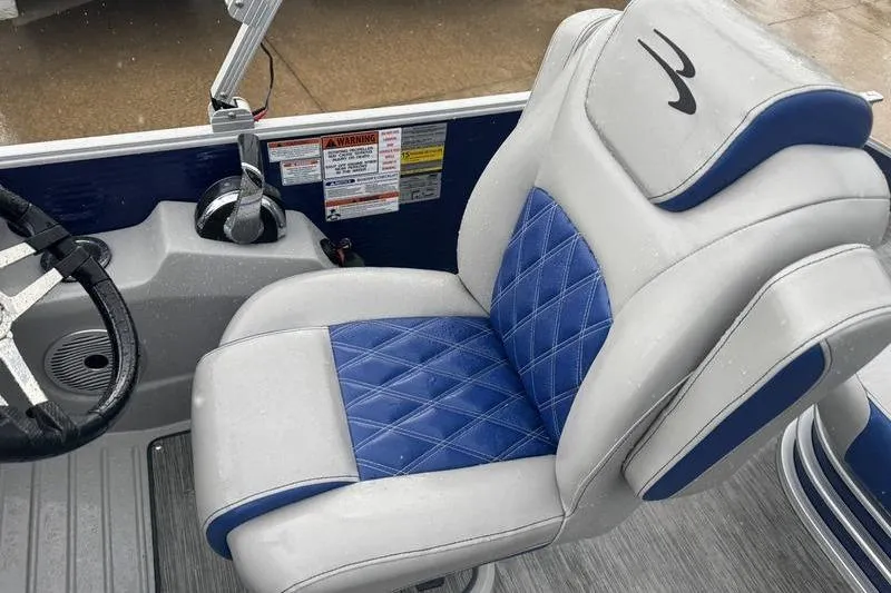 Slide: The Image of Luxurious seating in 2022 Bennington 26 LXSB boat with blue and gray upholstery. - 7